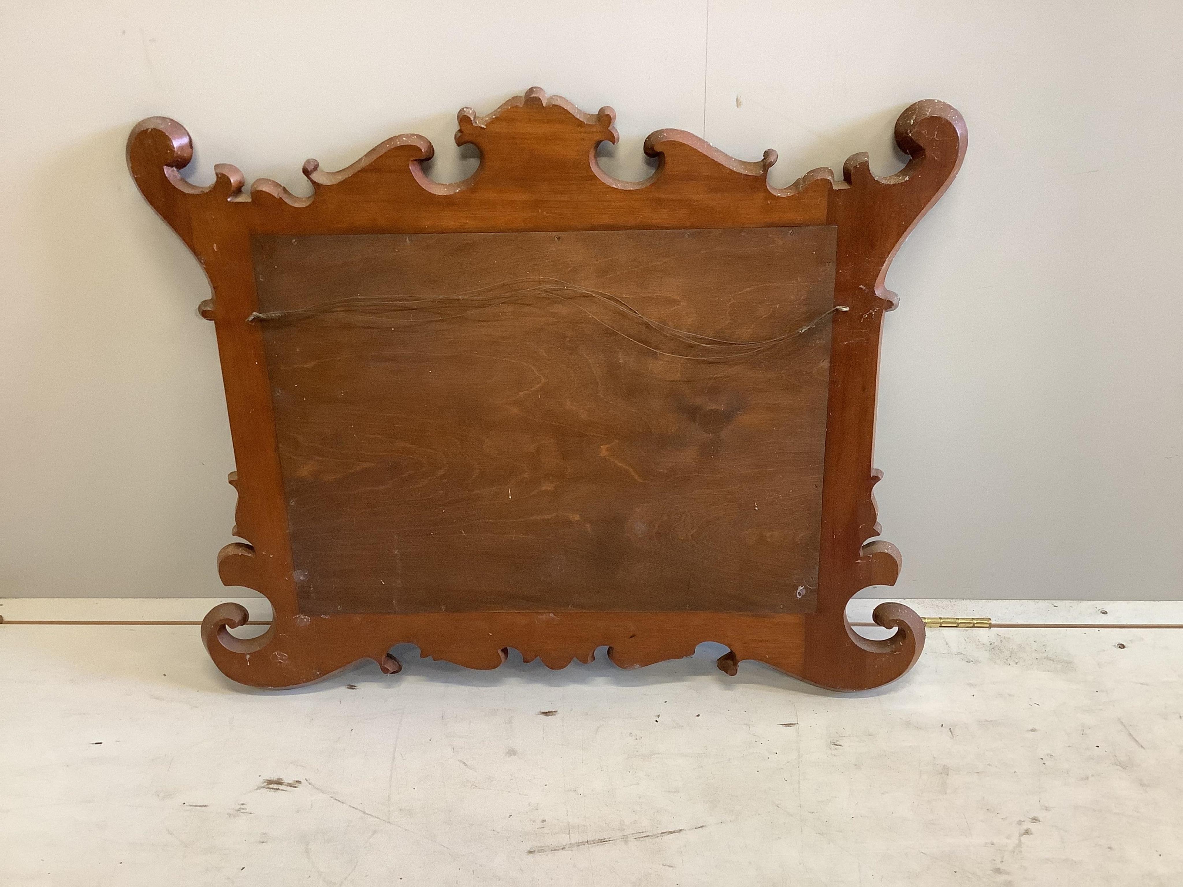 A George II style parcel gilt mahogany fret cut wall mirror, width 89cm, height 70cm. Condition - fair to good